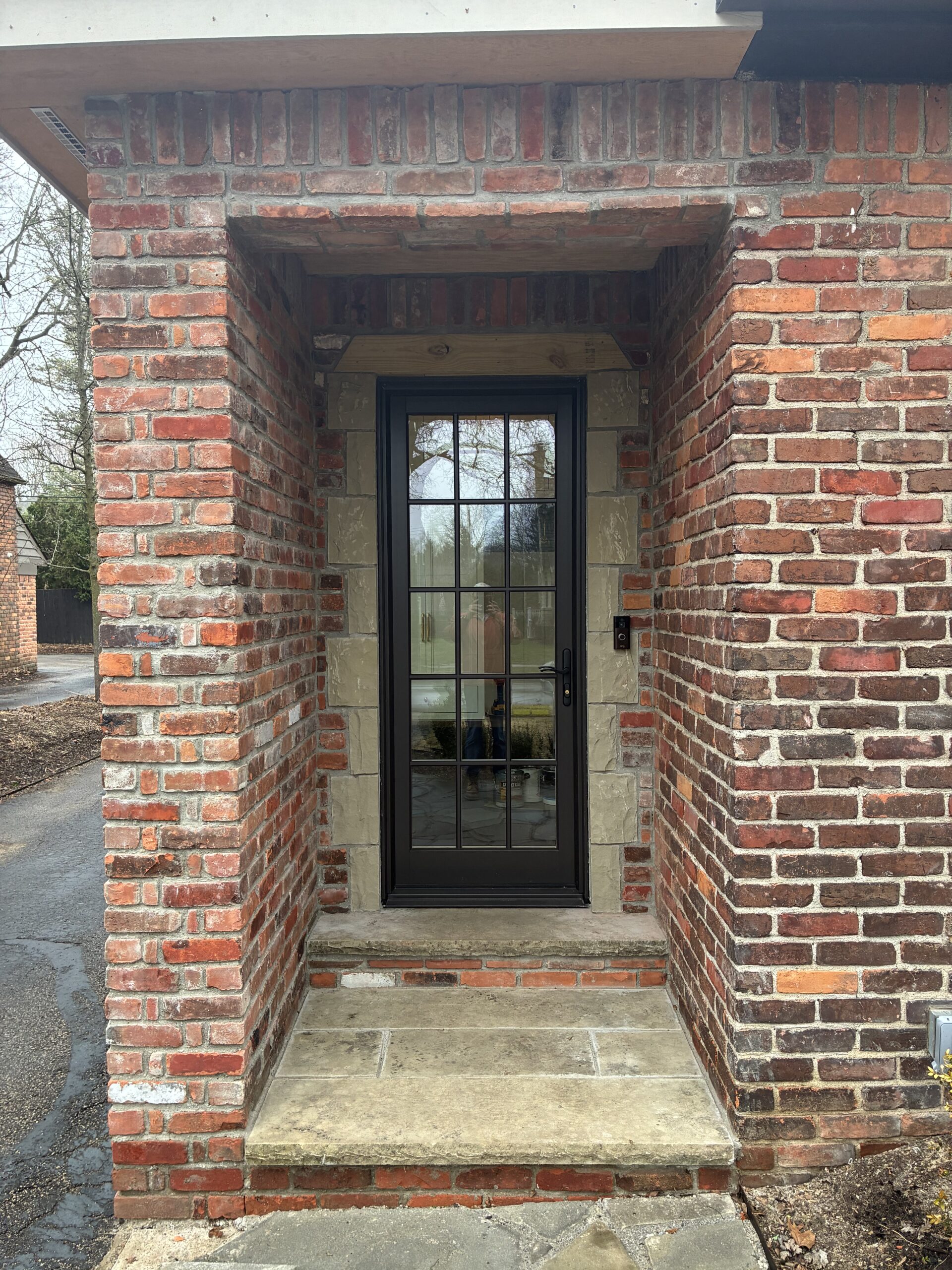 Custom limestone door surround with brick facade on addition in Birmingham, Michigan