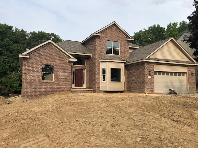 Brick facade on new home in Farmington, Michigan with custom window detail